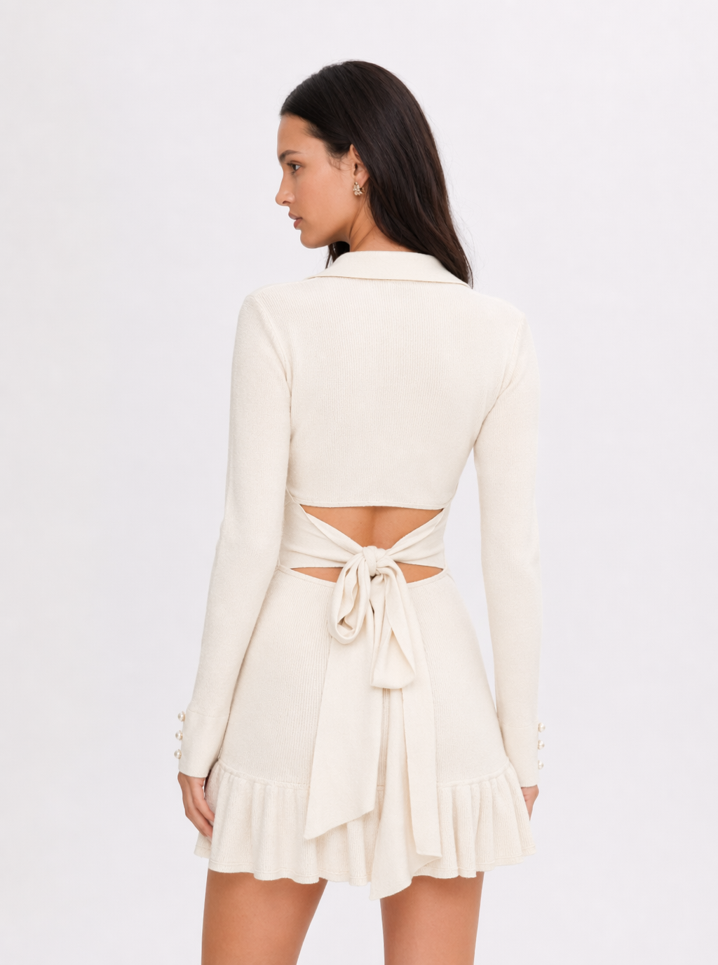 Back view of apricot knit mini dress with tie bow and ruffled hem