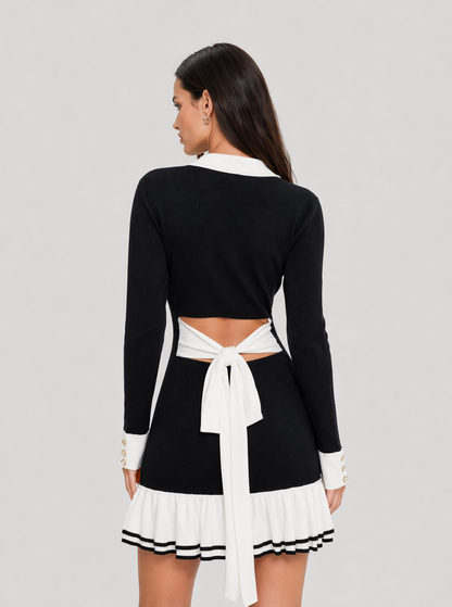 Back view of black knit mini dress with tie bow and ruffled hem