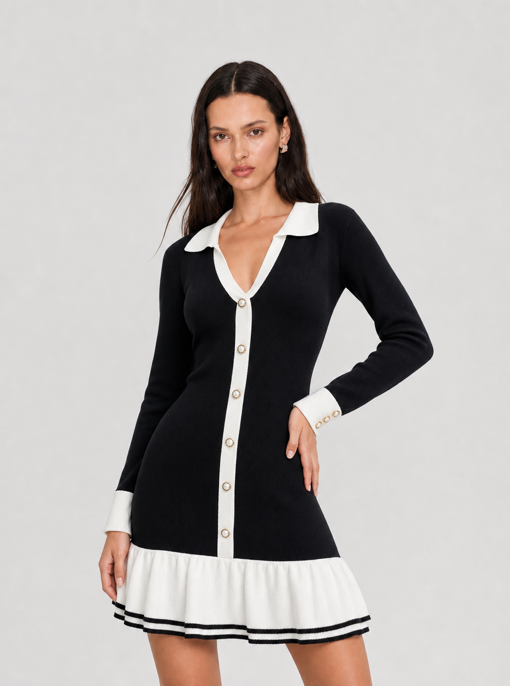 Black knit mini dress with white contrast collar, styled front pose