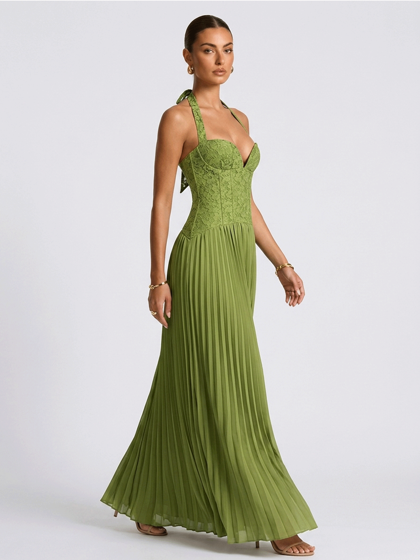 Green pleated chiffon gown seen from the side, full length
